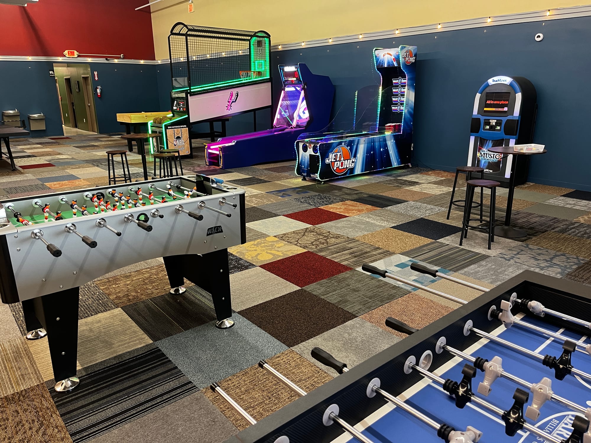 Rows of lit game cabinets in the Hawk's Nest game room